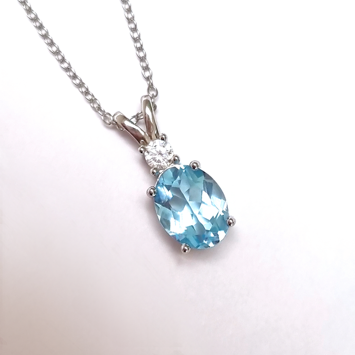Oval cut sky blue topaz pendant necklace in sterling silver