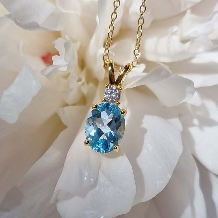 Oval cut sky blue topaz pendant necklace in 18k gold vermeil
