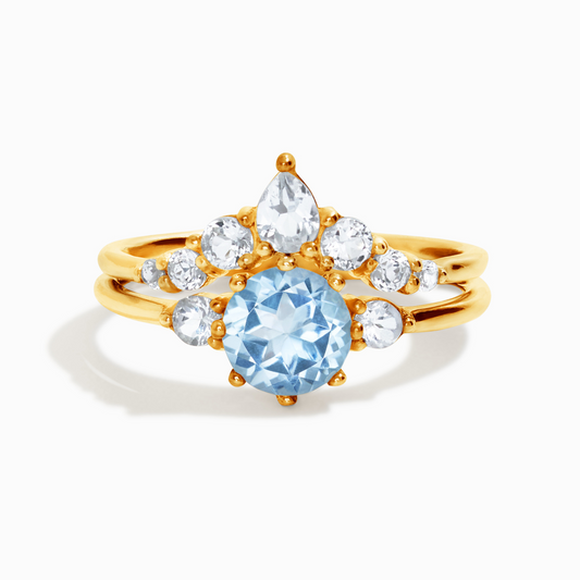 Round cut sky blue topaz and white topaz three stone engagement and wedding ring stack in 18K gold vermeil