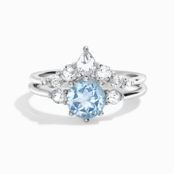 Round cut sky blue topaz and white topaz three stone engagement and wedding ring stack in sterling silver