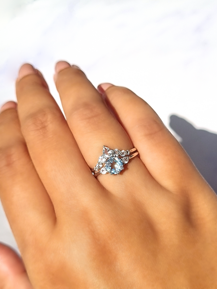 Round cut sky blue topaz and white topaz three stone engagement and wedding ring stack in sterling silver