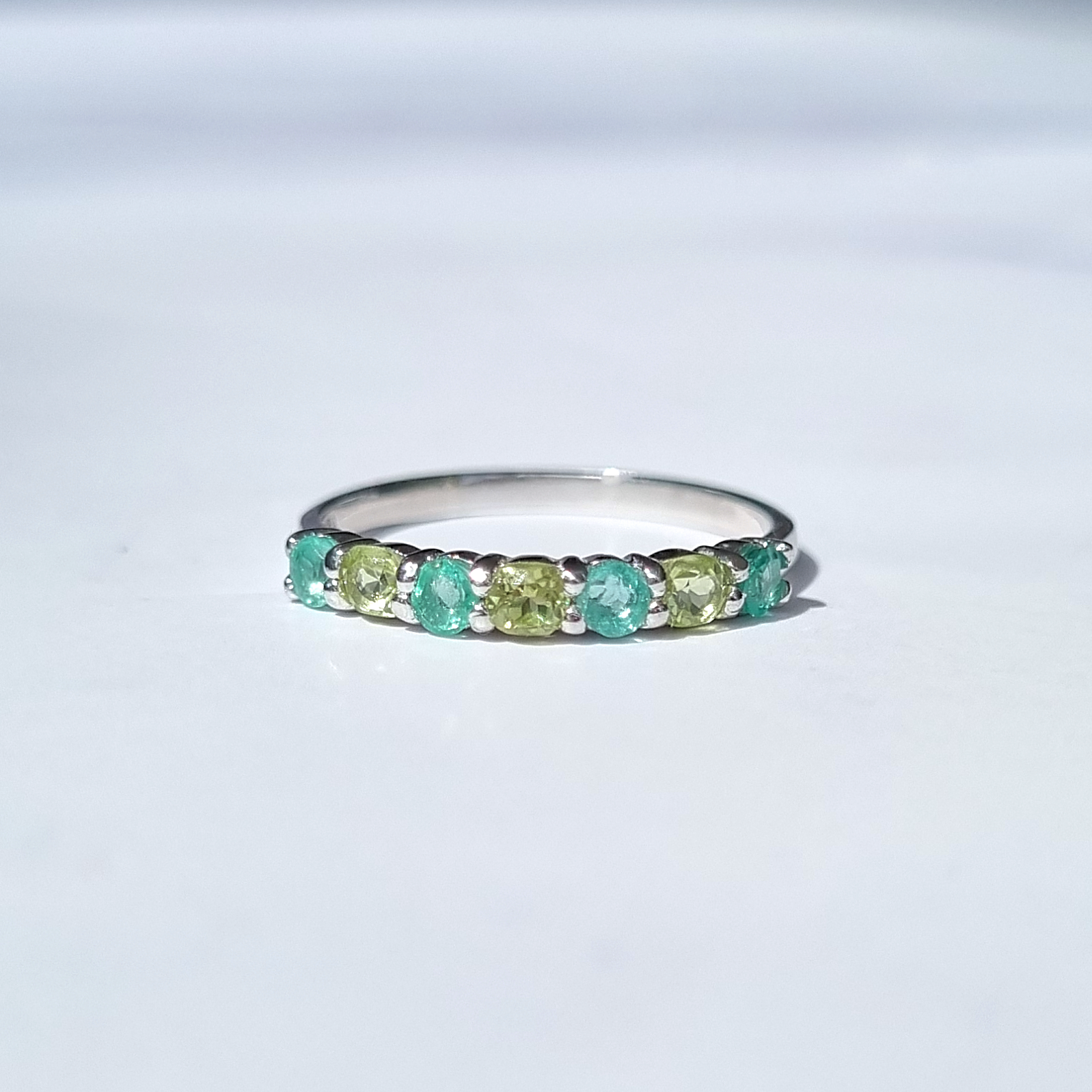 round cut emerald and oval cut peridot eternity stackable wedding ring in sterling sliver 