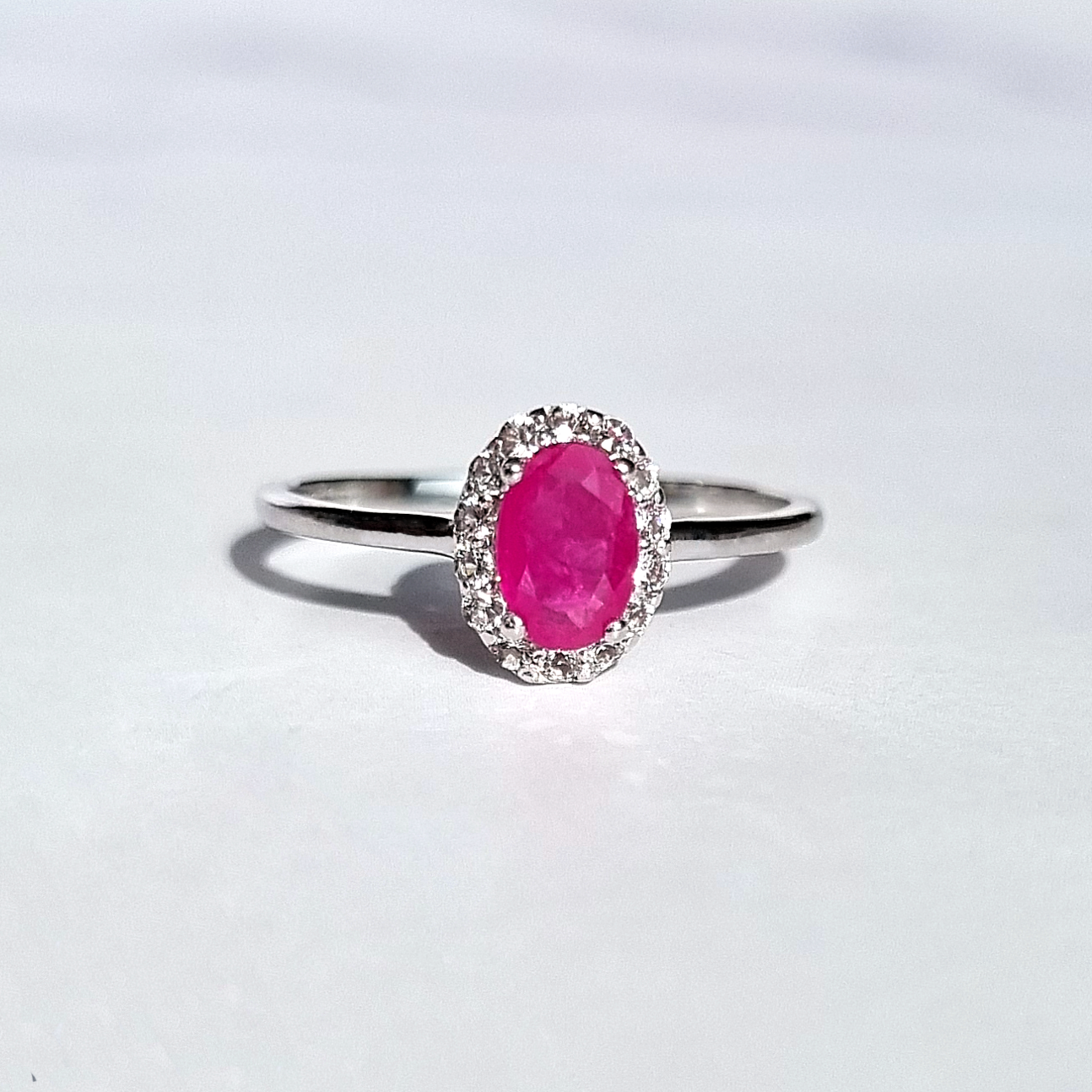  oval cut pinkish red gemstone and white topaz engagement , promise , wedding ring in sterling sliver